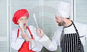 Kitchen rules. Culinary battle concept. Woman and bearded man culinary show competitors. Who cook better. Ultimate