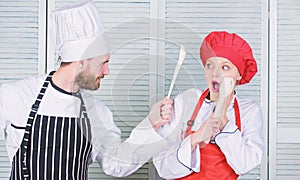 Kitchen rules. Culinary battle concept. Woman and bearded man culinary show competitors. Who cook better. Ultimate