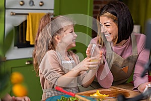 In the kitchen with a rustic design the mother and her cute daughter preparing the breakfast together woman add some