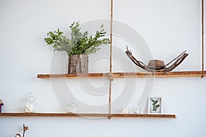 Kitchen in rustic style in summer. Spring light textured kitchen with an old fridge, wooden table. Hanging shelves made of solid w