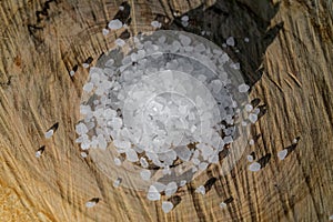 Kitchen salt grain ingredient on wood table, nacl, sodium chloride, food concept