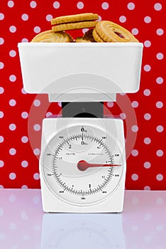 Kitchen scales with cookies diet concept