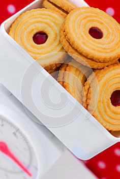 Kitchen scales with jam cookies diet concept