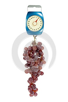 Kitchen scales and red grapes.