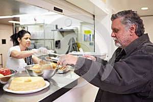 Kitchen Serving Food In Homeless Shelter