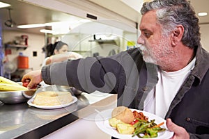 Kitchen Serving Food In Homeless Shelter