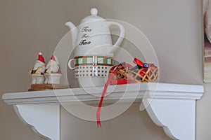 Kitchen shelf decors with eggs and teapot.