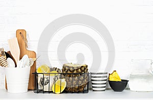 Kitchen shelf lifestyle white background with fresh lemons, pineapple, kitchen tools, appliances, chopping boards