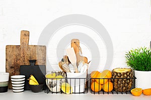 Kitchen shelf storage organization fruit cutlery. Home style minimalism zero waste. Still life with storage baskets of