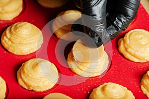 Placing craquelin on choux pastry photo