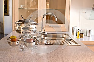 Kitchen sink with the crane and Utensils for fondu