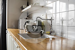 Kitchen sink and faucet. Stainless kitchen sink and tap water. The interior of the modern kitchen room in the loft