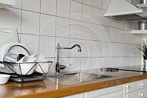 Kitchen sink and faucet. Stainless kitchen sink and tap water. The interior of the modern kitchen room in the loft