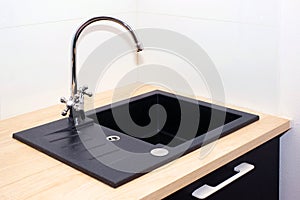 Kitchen sink and water tap in the kitchen in a modern apartment. Domestic Appliances.