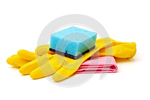 Kitchen sponge, yellow household gloves and red surface cleaning wipe isolated on white background