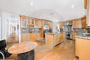 Kitchen with stainless appliances and counters on wooden floor in Encino, CA