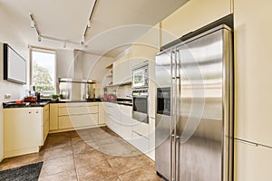 a kitchen with stainless steel appliances and white cabinets