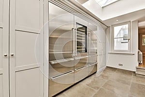 a kitchen with stainless steel appliances and white cabinets