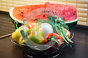 Kitchen still life. Fresh raw sweet peppers with onion and verdure and water melon.