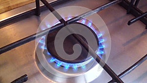Kitchen stove. The gas is on, the burner is on with the sound of burning. Close-up video, real life