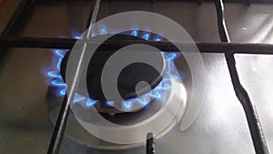 Kitchen stove. The gas is on, the burner is on with the sound of burning. Close-up video, real life