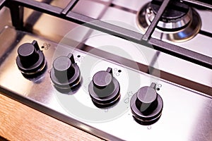 kitchen stove top. Gas cooker with burning flames of propane gas.Modern hob gas stove made of tempered white glass using