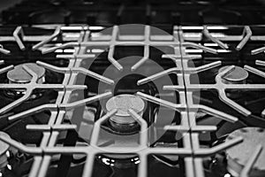 Kitchen surface in stainless steel with cast iron grill. View from above. Stove hob cooking kitchen cooker metal burner