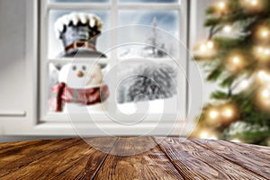 Kitchen table with christmas decorations and blurred kitchen background.