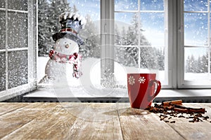 Kitchen table with christmas decorations and blurred kitchen background.