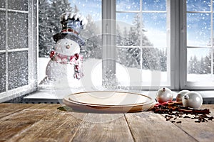 Kitchen table with christmas decorations blurred kitchen background.