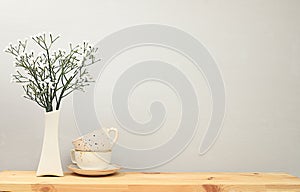 Kitchen table with coffee cups and spring flowers. Simple home kitchen interior, mockup for product design and display, zero waste