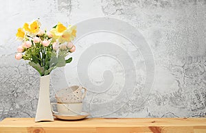 Kitchen table with coffee cups and spring flowers. Simple home kitchen interior, mockup for product design and display, zero waste
