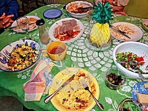 Kitchen Table Covered With The Remains of an Italian Meal