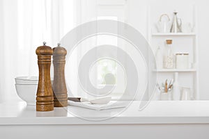 Kitchen table with food ingredients and kitchenware and blurred window