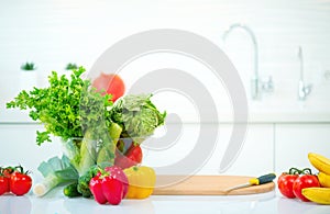 Kitchen table with fresh organic vegetables and fruits