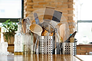 kitchen table.metal stands with cutlery,glass bottles with olive oil and vinegar