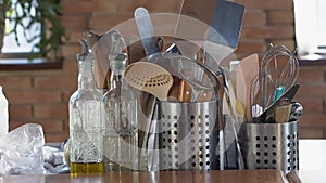 kitchen table.metal stands with cutlery,glass bottles with olive oil and vinegar