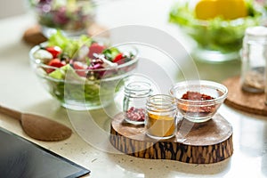 Kitchen table with salad spices and wooden spoonula