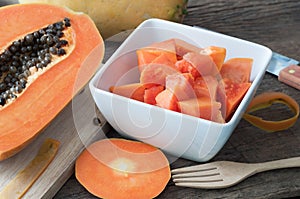 Kitchen table with slice fresh papaya on wood plate, Fruit for t