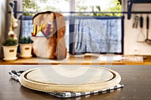 Kitchen table top with empty space for products or decoration, yellow schoolbag, blurred spring outside the window background.