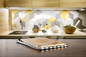 Kitchen table top with empty space for you products or decoration and blurred kitchen furniture background.