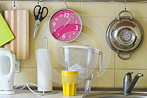 Kitchen table with water filter, clock