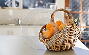 Kitchen tabletop and basket of oranges