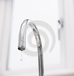 Kitchen tap isolated on bright background. Water saving solutions