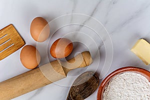 Kitchen tools, eggs, flour and butter