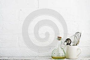 Kitchen tools on a kitchen shelf against a white brick wall. selective focus