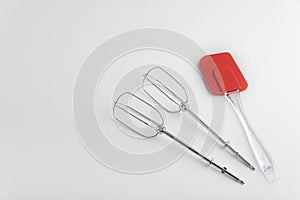 Kitchen tools mixer whiskas and kitchen red silicone spatula on white background