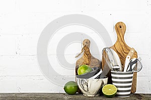 Kitchen tools, olive cutting board on a kitchen shelf against a white brick wall. selective focus