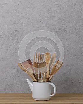 Kitchen tools, utensils and kitchenware on the table on a grey concrete background.