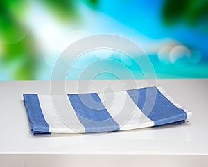 Kitchen towel cloth on white table resort nature background.